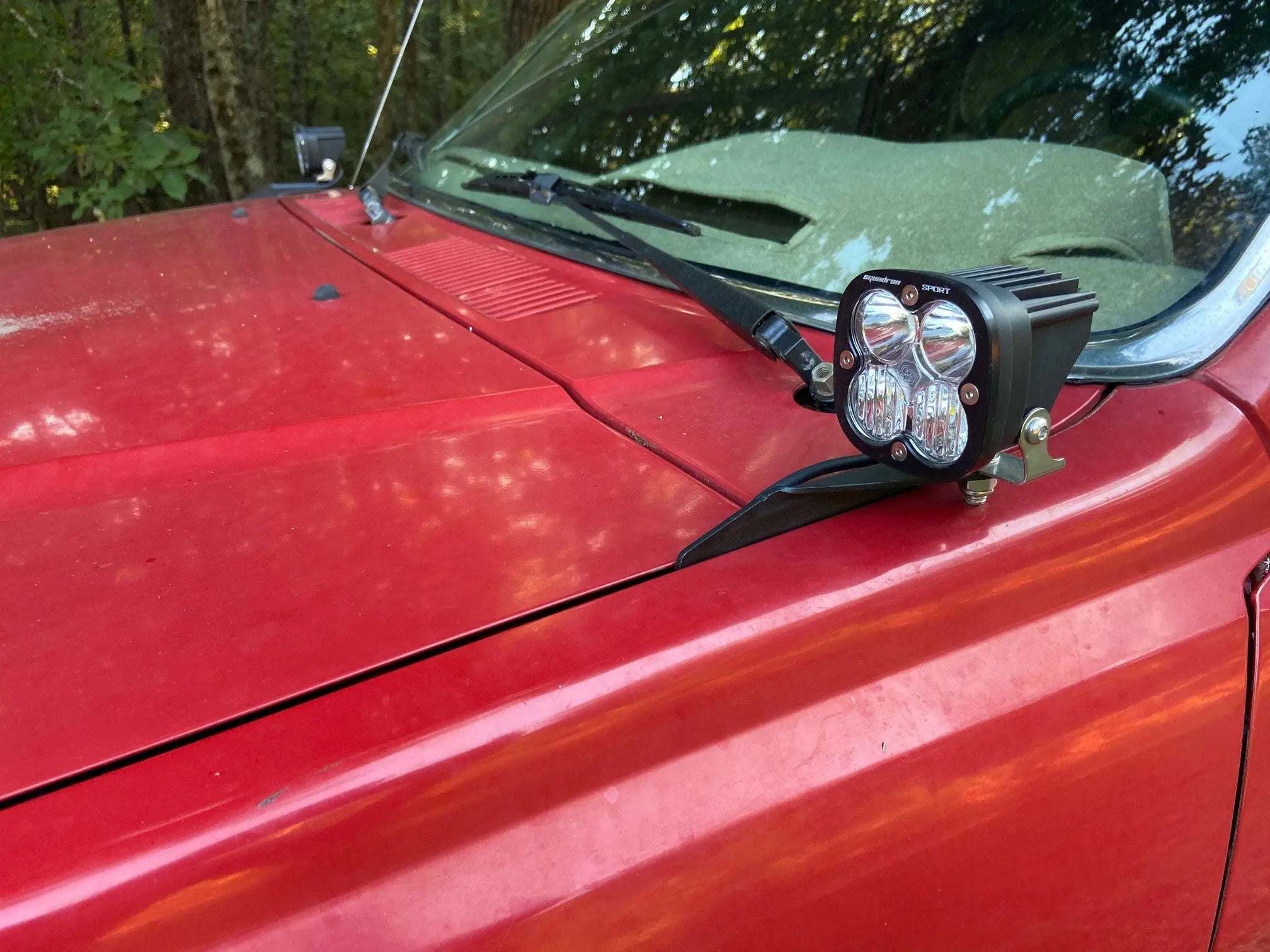 1985-1988 Toyota Hilux hood ditch light mounts with black powder coat finish installed on truck hood