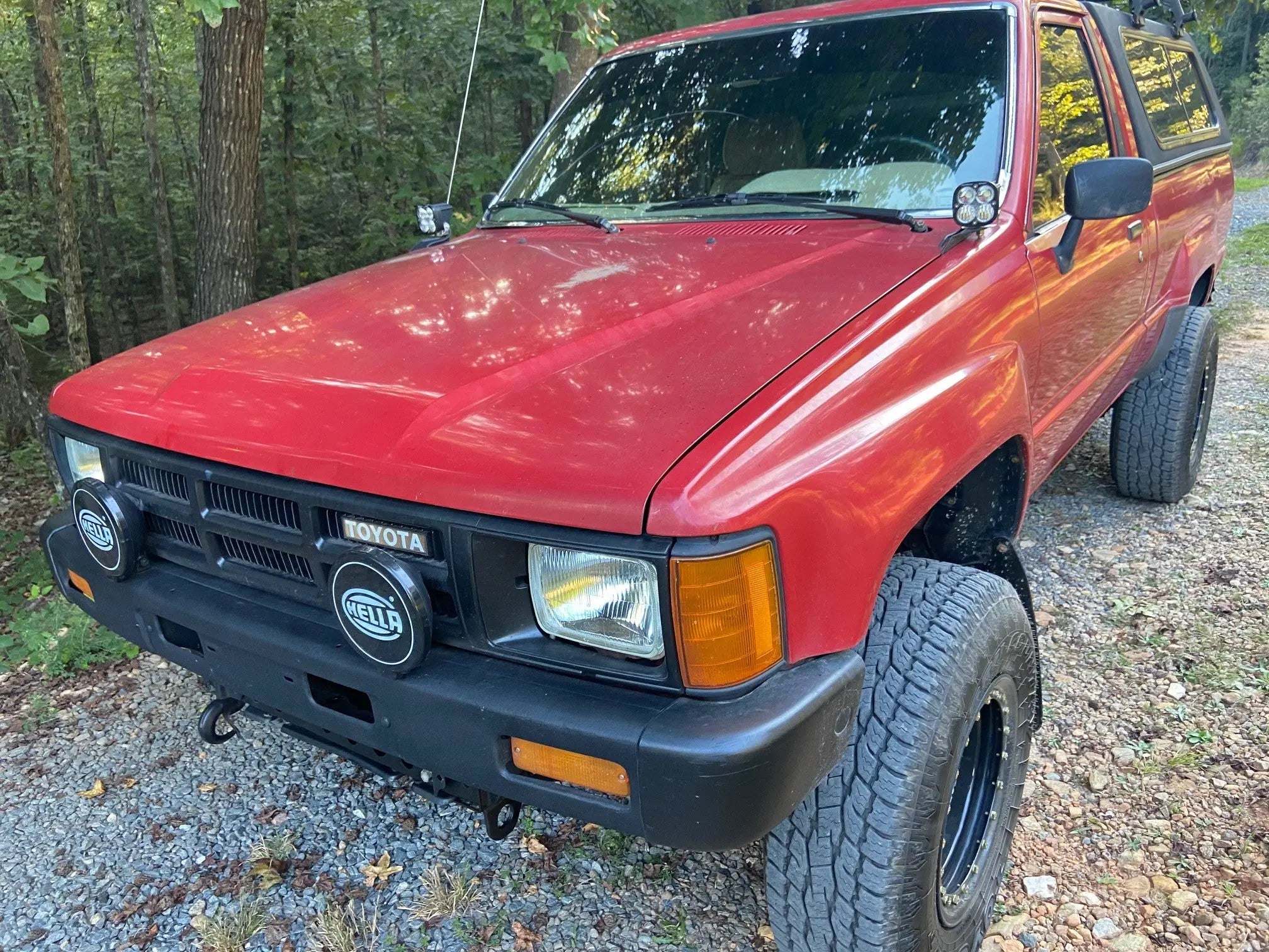 1985-1988 Toyota Hilux hood ditch light mounts installed on truck hood with black powder coat finish